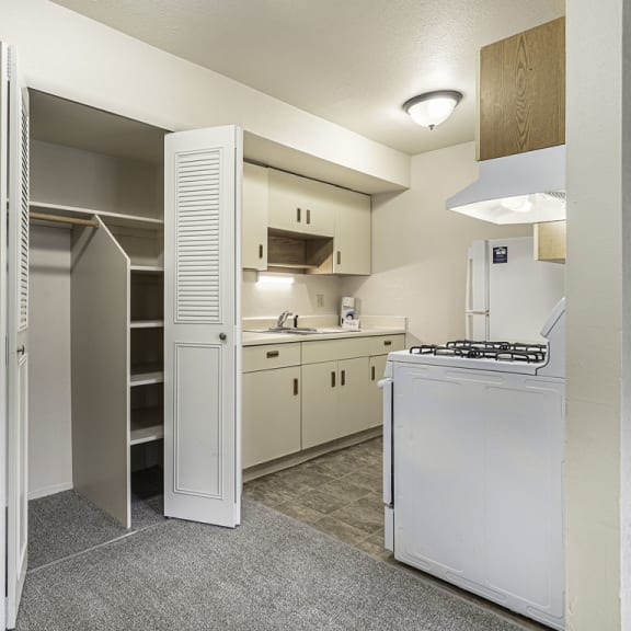 Thumbnail 9 of 19 a kitchen with white appliances and a closet at Normandy Village Apartments, Michigan City, 46360