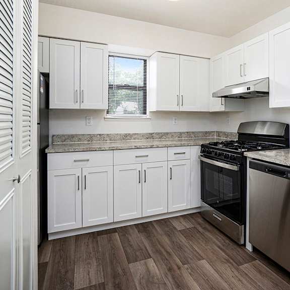 Thumbnail 5 of 10 A kitchen with white cabinets at North Pointe Apartments, Elkhart, IN, 46514