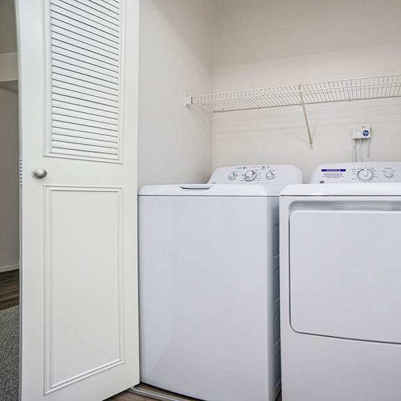 Thumbnail 8 of 10 A full size washer and dryer in a small laundry room at North Pointe Apartments, Elkhart, IN, 46514