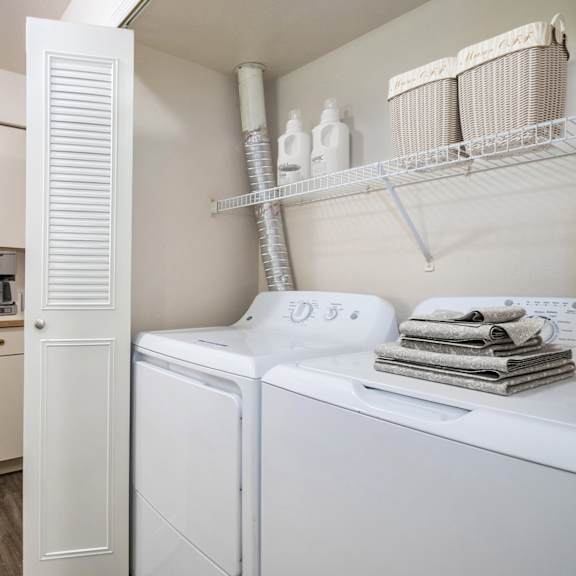 Thumbnail 4 of 12 A kitchen laundry area with a washer and dryer at North Pointe Apartments, Elkhart, IN, 46514