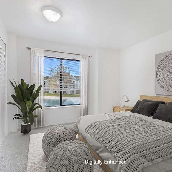 Thumbnail 13 of 17 bedroom with a large window and carpeting at North Pointe Apartments, Indiana, 46514