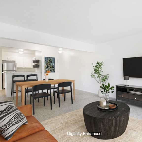 Thumbnail 5 of 17 A modern living room with a wooden coffee table and a flat screen TV at North Pointe Apartments, Indiana, 46514