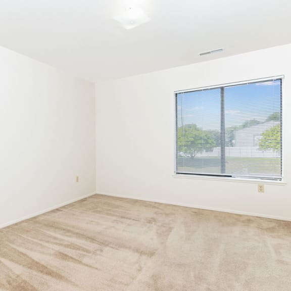 Thumbnail 9 of 11 an empty room with a window and white walls  at Oak Shores Apartments, Oak Creek, 53154