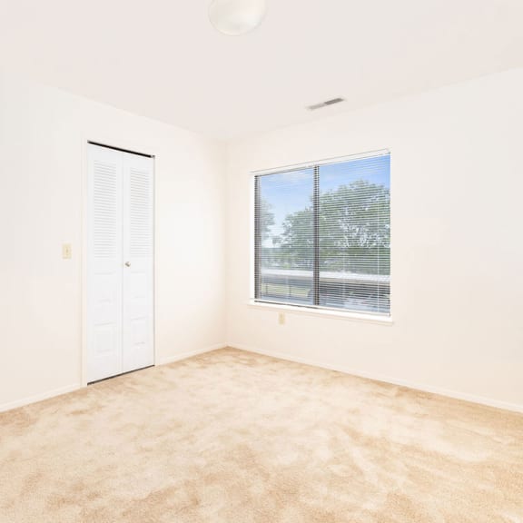 Thumbnail 9 of 9 an empty room with a window and a door  at Oak Shores Apartments, Oak Creek, 53154
