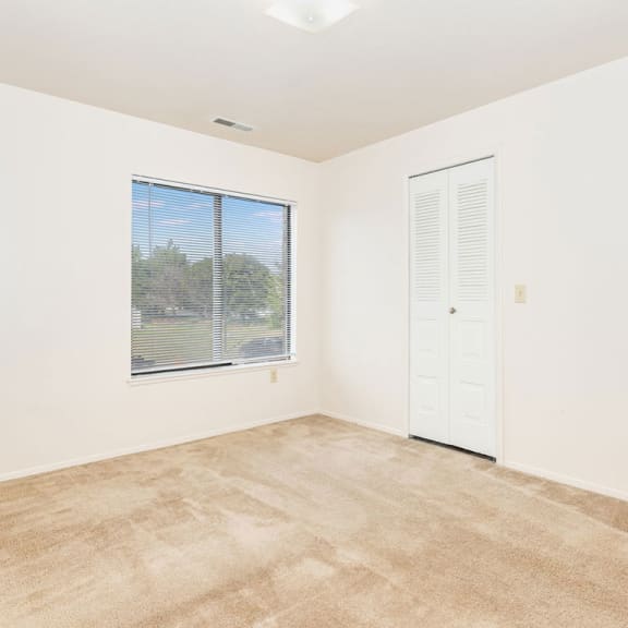 Thumbnail 11 of 11 an empty room with a window and a door  at Oak Shores Apartments, Oak Creek, 53154