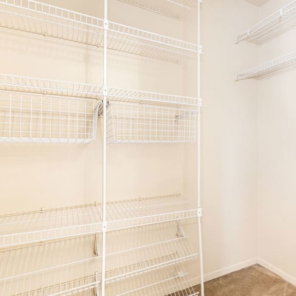 Thumbnail 10 of 11 a white closet with empty shelves in a room  at Oak Shores Apartments, Oak Creek, 53154