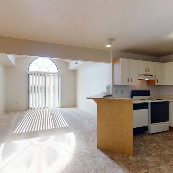 Thumbnail 3 of 9 an empty kitchen with an island in the middle  at Oak Shores Apartments, Oak Creek, 53154