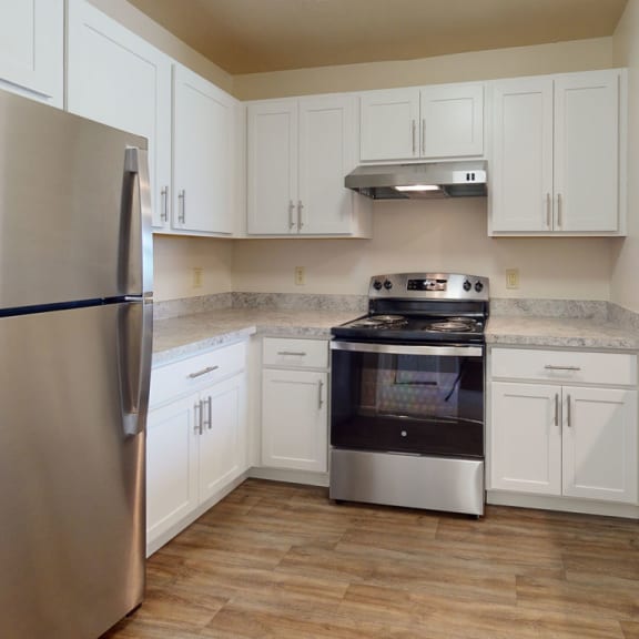 Thumbnail 5 of 9 a kitchen with stainless steel appliances and white cabinets  at Oak Shores Apartments, Oak Creek, 53154