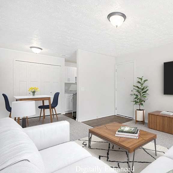 Thumbnail 4 of 13 A modern living room leading to a dining room with a closet at Old Farm Apartments, Elkhart, 46517