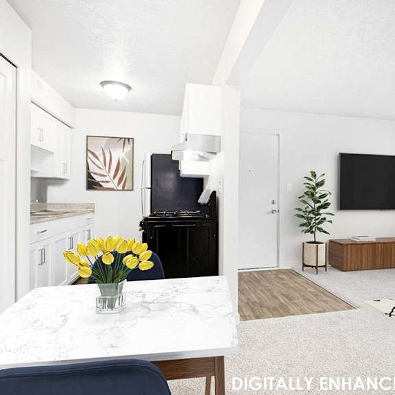 Thumbnail 5 of 13 A white kitchen and dining room with a table and chairs at Old Farm Apartments, Elkhart, 46517