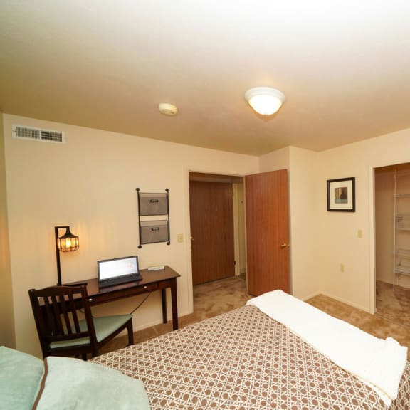 Thumbnail 7 of 7 a bedroom with a bed and a desk at Orchard Lakes Apartments, Toledo