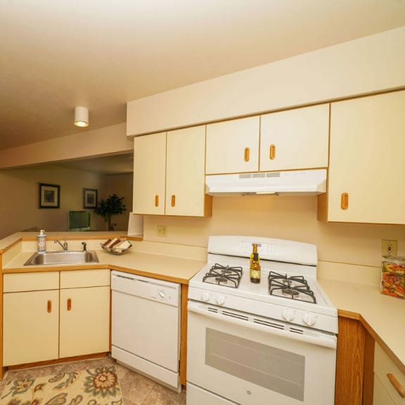 Thumbnail 4 of 7 a kitchen with a stove and a sink at Orchard Lakes Apartments, Toledo, Ohio