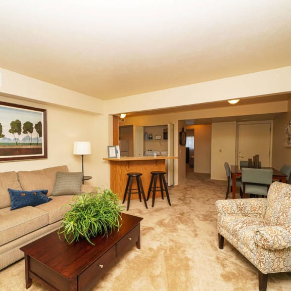 Thumbnail 3 of 7 a living room with a couch and a table at Orchard Lakes Apartments, Ohio, 43615