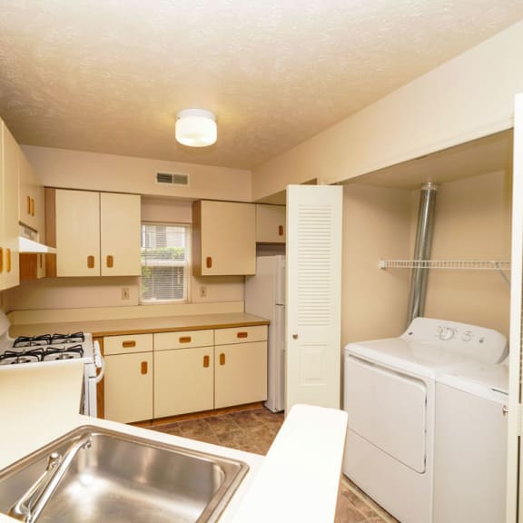 Thumbnail 5 of 5 a kitchen with a sink and a washer and dryer at Orchard Lakes Apartments, Toledo, OH, 43615