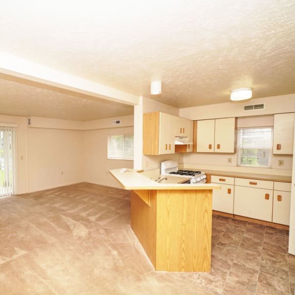 Thumbnail 3 of 5 a kitchen with an island in the middle of a living room at Orchard Lakes Apartments, Ohio, 43615