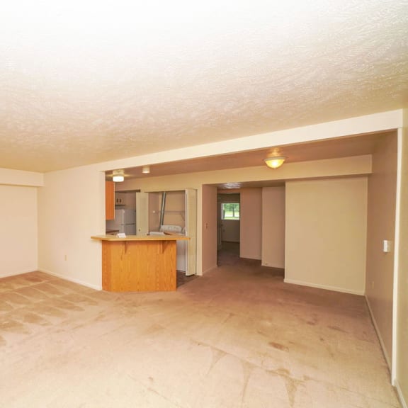 Thumbnail 4 of 5 the living room and kitchen of an empty house at Orchard Lakes Apartments, Ohio, 43615