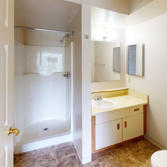 Thumbnail 12 of 12 a bathroom with a toilet and a sink and a shower at Orchard Lakes Apartments, Toledo, 43615