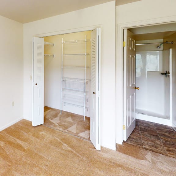 Thumbnail 11 of 12 a bedroom with a closet and a mirrored closet door at Orchard Lakes Apartments, Toledo, OH