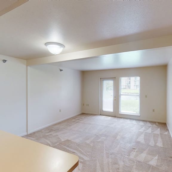 Thumbnail 4 of 12 the living room and dining room of an empty apartment at Orchard Lakes Apartments, Toledo, 43615