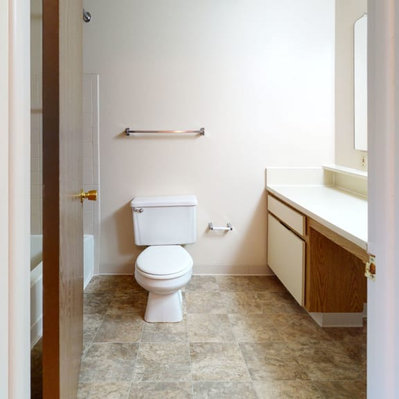 Thumbnail 5 of 7 a bathroom with a toilet and a sink  at Pine Knoll Apartments, Battle Creek, 49014