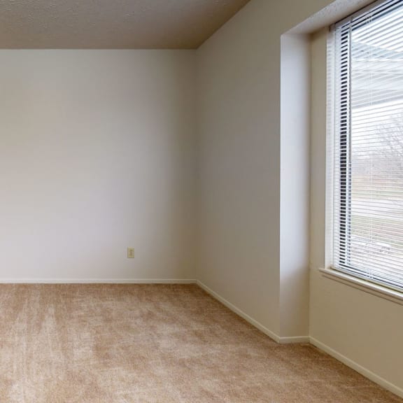 Thumbnail 7 of 7 an empty room with a large window and carpeting at Pine Knoll Apartments, Battle Creek, 49014