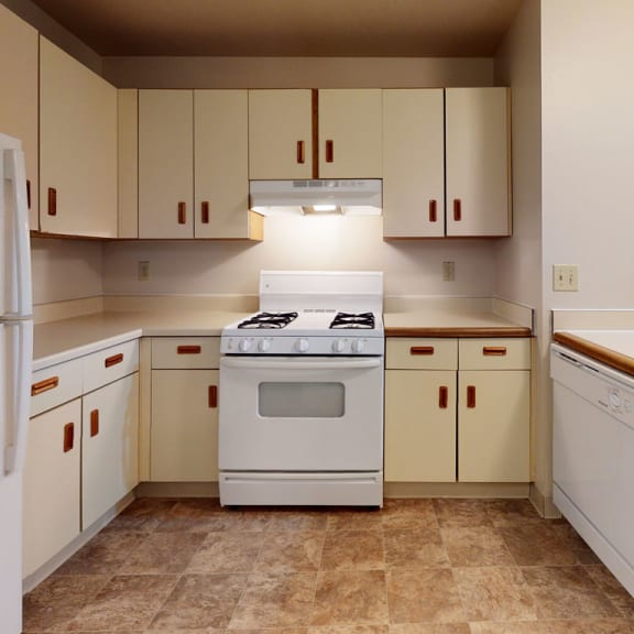 Thumbnail 4 of 8 a kitchen with white appliances and white cabinets at Pine Knoll Apartments, Battle Creek