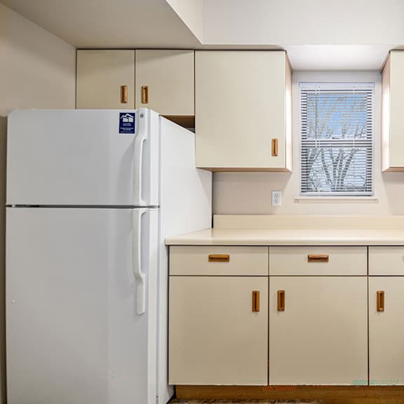 Thumbnail 6 of 9 A kitchen with a window at Pine Knoll Apartments, Battle Creek, MI