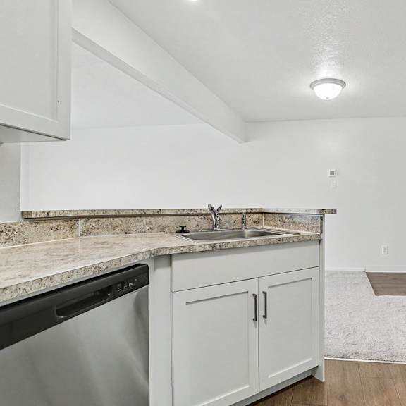 Thumbnail 10 of 17 A white laundry area with a washer and dryer at Pine Knoll Apartments, Battle Creek