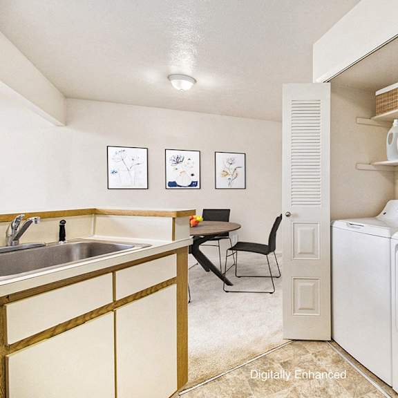 Thumbnail 8 of 11 A kitchen with a full size washer and dryer at Pine Knoll Apartments, Battle Creek