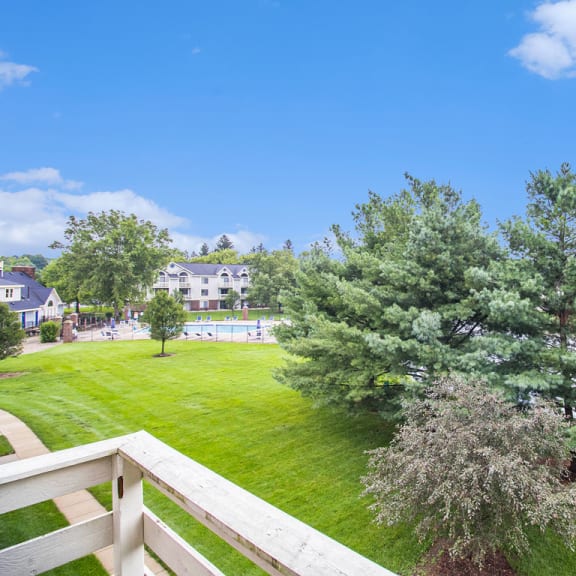 Thumbnail 6 of 11 the view of a pond from a balcony with trees at Pine Knoll Apartments, Battle Creek, 49014