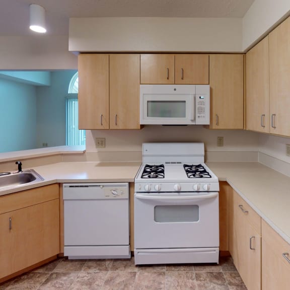 Thumbnail 9 of 13 a kitchen with a dishwasher and a microwave at Hunters Pond Apartment Homes, Illinois, 61820