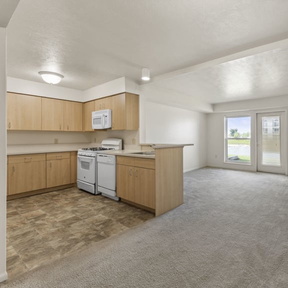Thumbnail 3 of 13 kitchen and oversized living area at Hunters Pond Apartment Homes, Illinois, 61820