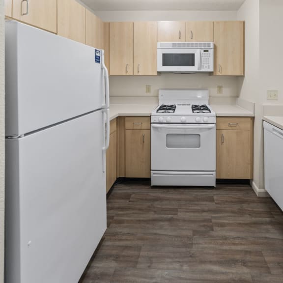 Thumbnail 7 of 18 a kitchen with white appliances and wooden cabinets at Hunters Pond Apartment Homes, Champaign, IL, 61820