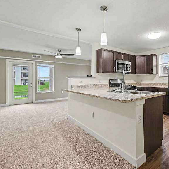 Thumbnail 5 of 12 A kitchen with a pantry and stainless steel appliances at The Reserve at The Reserve at Destination Pointe in Grimes, IA 50111