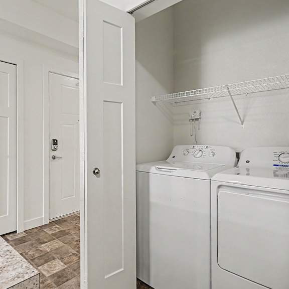 Thumbnail 9 of 12 A laundry area with a washer and dryer at The Reserve at The Reserve at Destination Pointe in Grimes, IA 50111