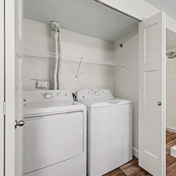 Thumbnail 12 of 16 A white laundry area with a washer and dryer at The Reserve at The Reserve at Destination Pointe in Grimes, IA 50111
