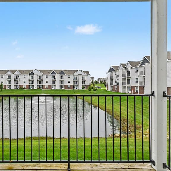 Thumbnail 5 of 16 A balcony view of a pond with fountain at The Reserve at The Reserve at Destination Pointe in Grimes, IA 50111