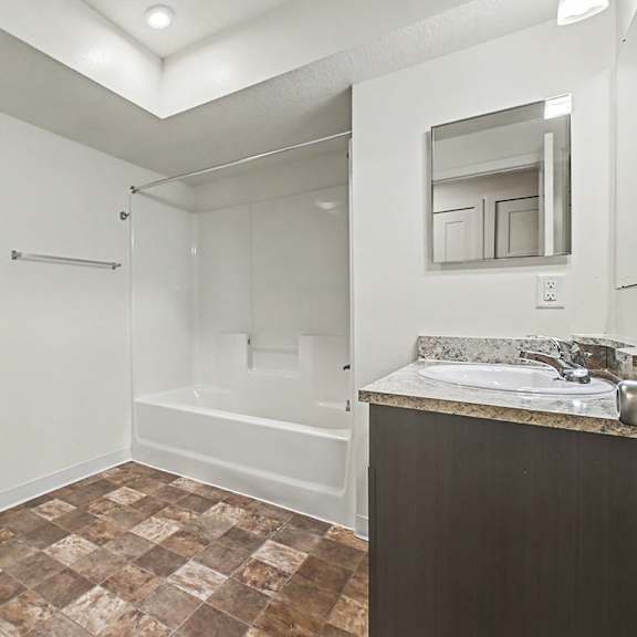Thumbnail 10 of 16 A bathroom with a toilet, sink, and bathtub at The Reserve at The Reserve at Destination Pointe in Grimes, IA 50111