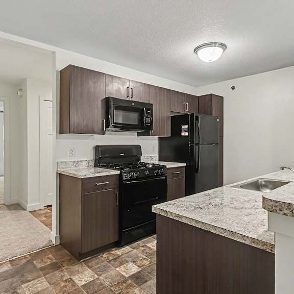 Thumbnail 8 of 16 A kitchen with a breakfast bar at The Reserve at The Reserve at Destination Pointe in Grimes, IA 50111
