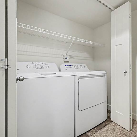 Thumbnail 9 of 16 A full-size washer and dryer in a small laundry room at The Reserve at The Reserve at Destination Pointe in Grimes, IA 50111