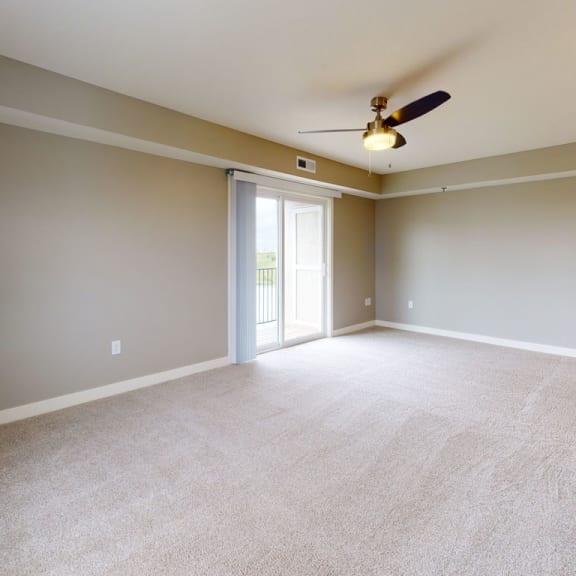 Thumbnail 3 of 7 an empty living room with a ceiling fan at The Reserve at Destination Pointe, Grimes, IA, 50111