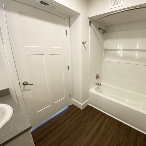Thumbnail 10 of 14 A bathroom with a bathtub and shower at Green Ridge Apartments, Michigan, 49544
