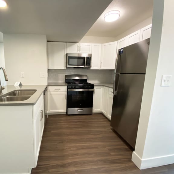 Thumbnail 6 of 14 A kitchen with stainless steel appliances at Green Ridge Apartments, Grand Rapids, MI, 49544