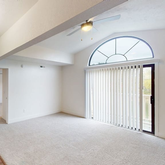Thumbnail 4 of 14 an empty living room with white walls and a large window at Green Ridge Apartments, Grand Rapids, Michigan