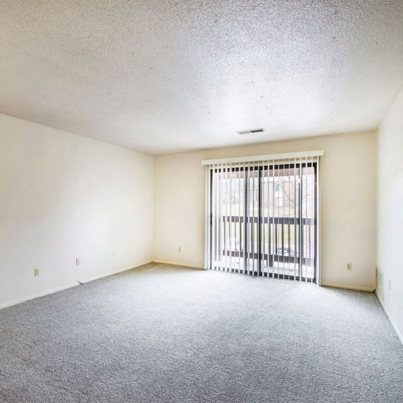 Thumbnail 5 of 10 living room with access to private balcony at Seville Apartments, Kalamazoo, MI, 49009