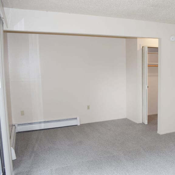 Thumbnail 9 of 12 living and dining areas with a closet at Seville Apartments, Kalamazoo, 49009