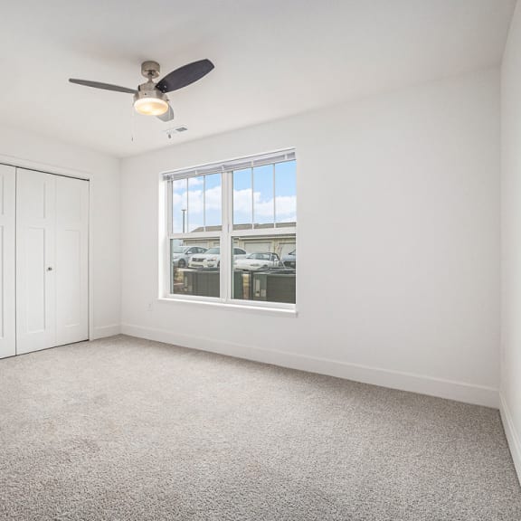 Thumbnail 13 of 14 Bedroom with a ceiling fan and large windows  at Signature Pointe Apartment Homes, Athens, Alabama