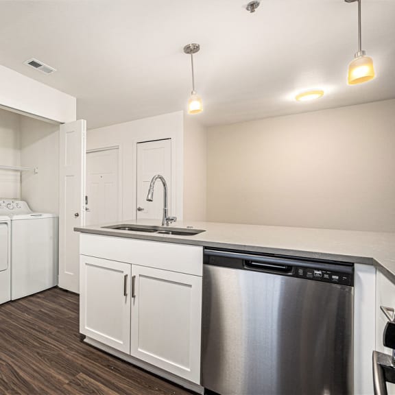 Thumbnail 9 of 12 a kitchen with a full-size washer and dryer  at Signature Pointe Apartment Homes, Athens, 35611