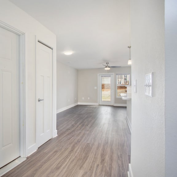 Thumbnail 5 of 14 Entry hallway with wood floors leading to living room  at Signature Pointe Apartment Homes, Athens, 35611