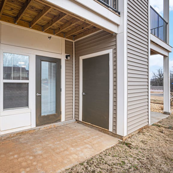 Thumbnail 7 of 14 the patio of an apartment with a door to enclosed storage  at Signature Pointe Apartment Homes, Alabama, 35611